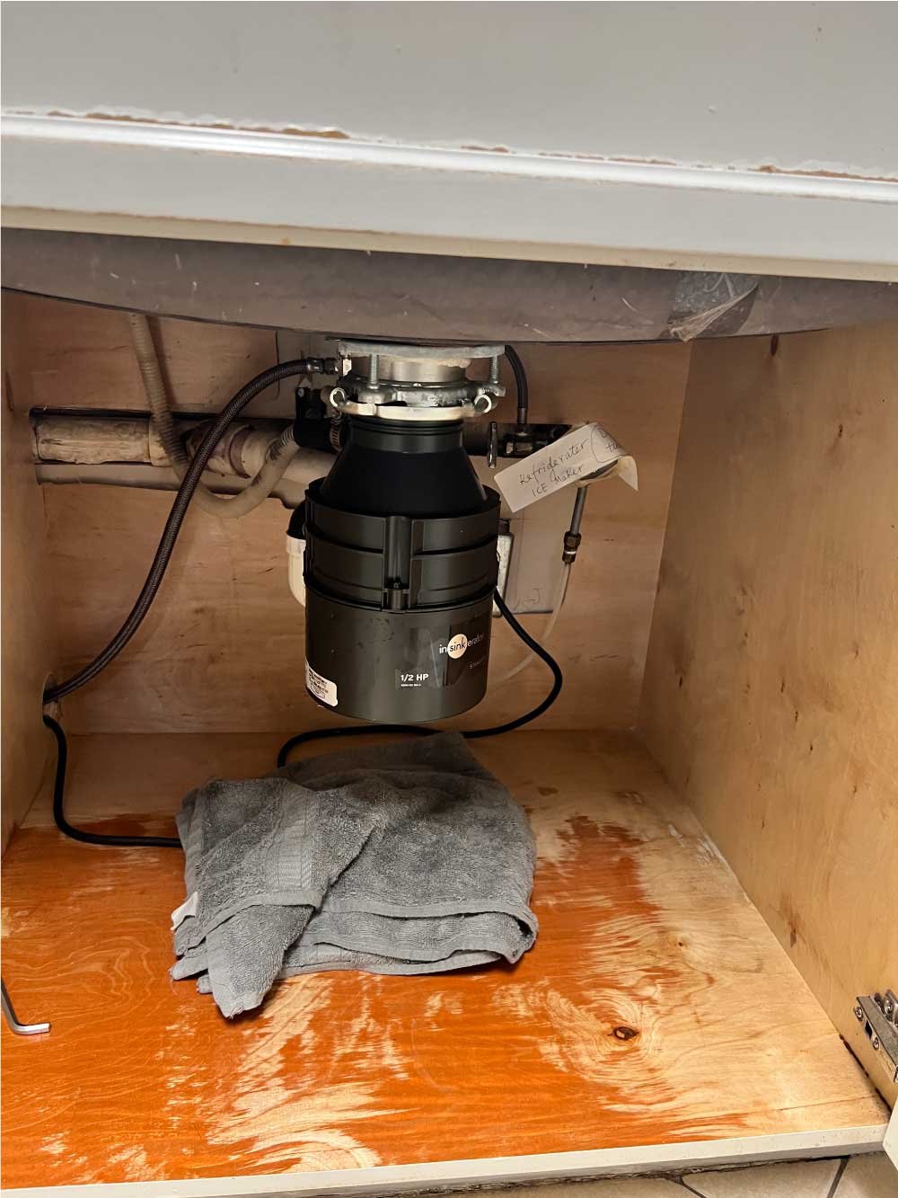 New garbage disposal installed under a kitchen sink