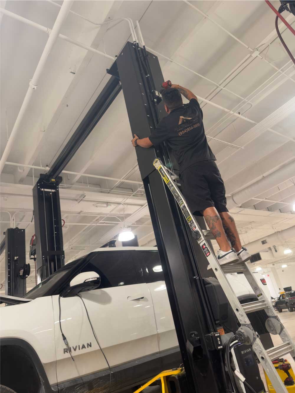 Technician on a lift performing overhead repairs at a commercial property