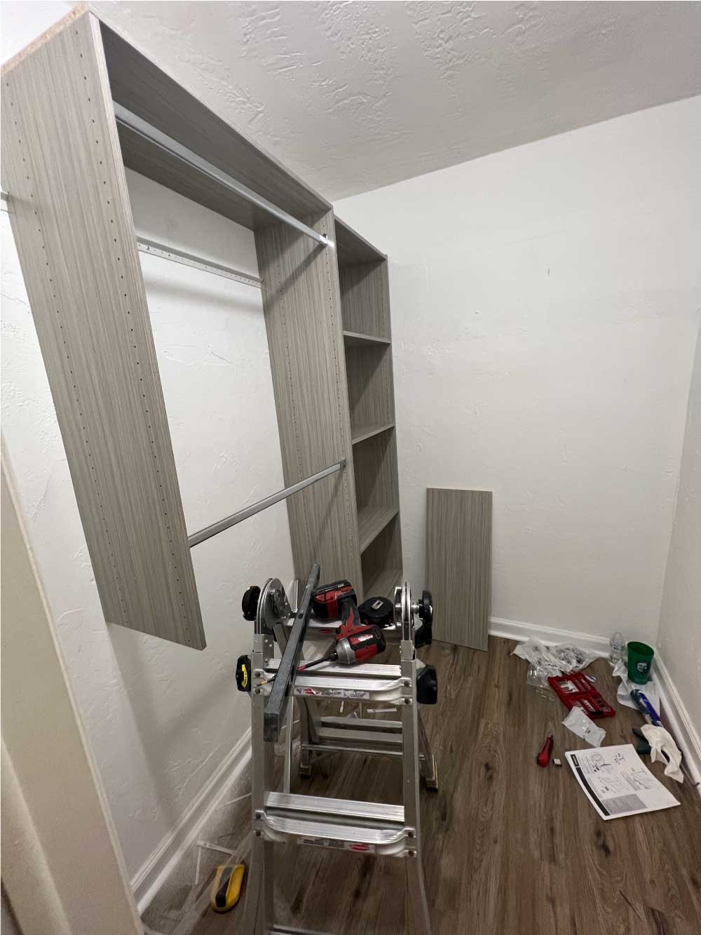 Built-in closet shelving being installed in a bedroom