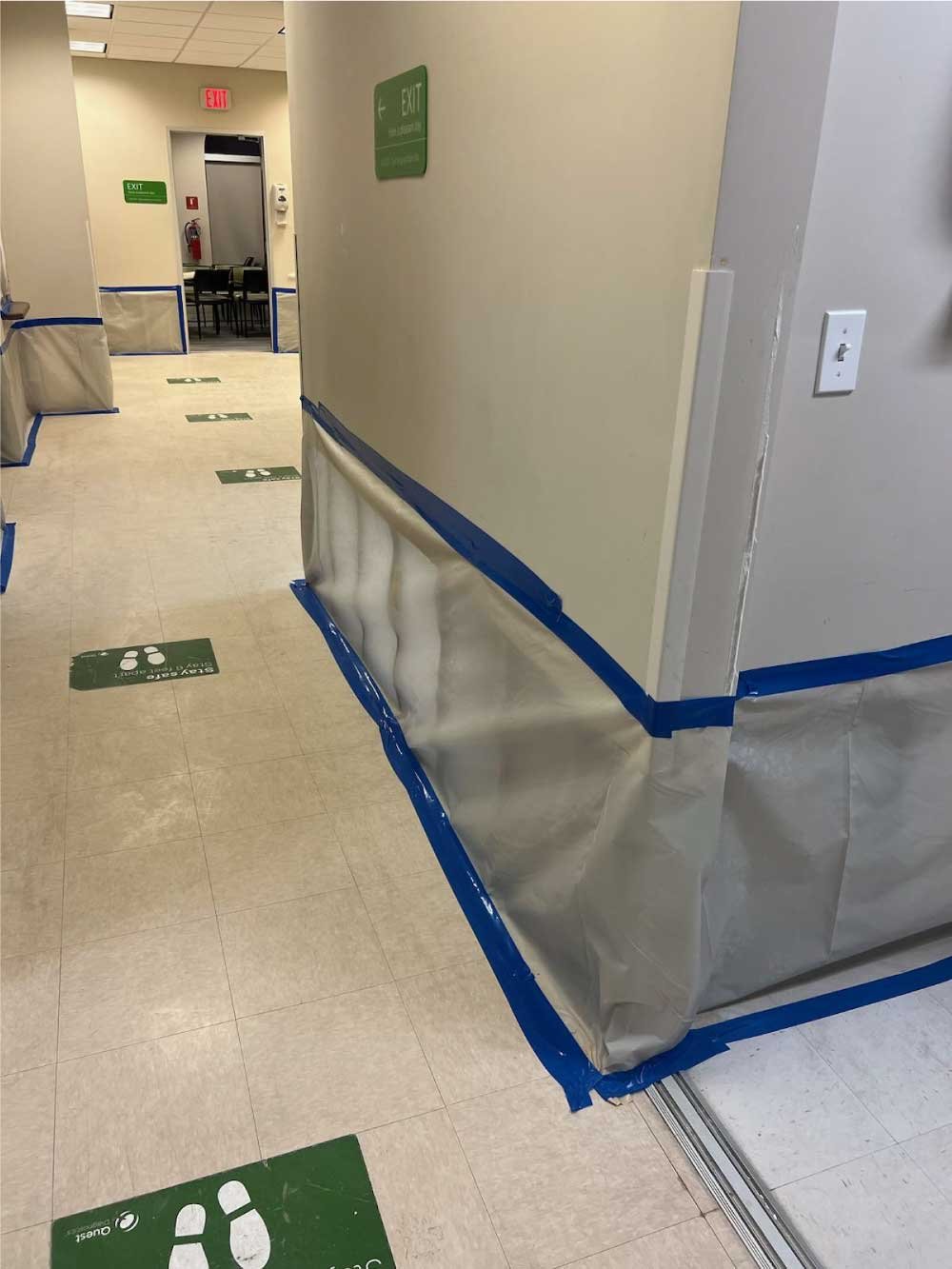Commercial hallway protected with plastic sheeting during a renovation