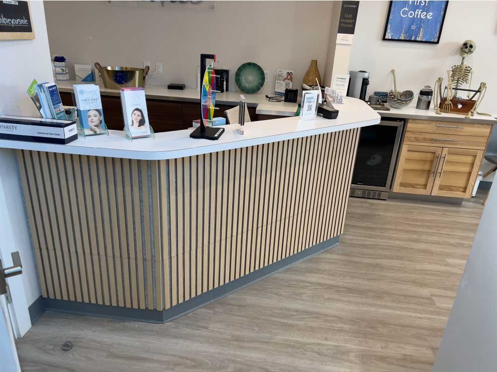 Custom reception desk and front counter in a commercial office remodel