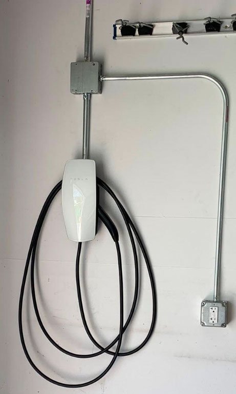 Home EV charger mounted on a wall after professional installation