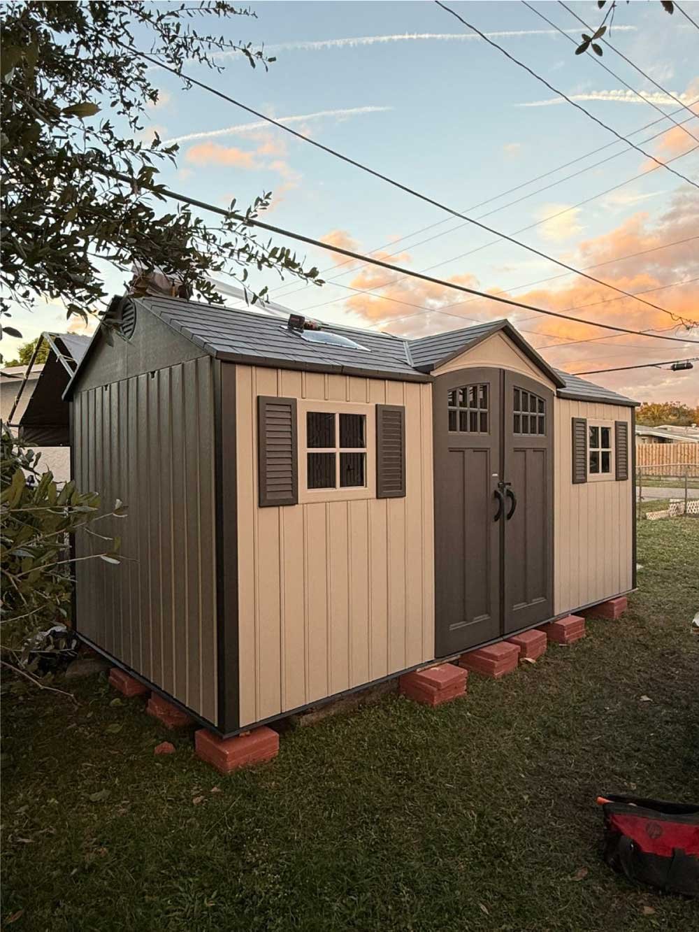 Backyard storage shed installed and leveled on a paver base