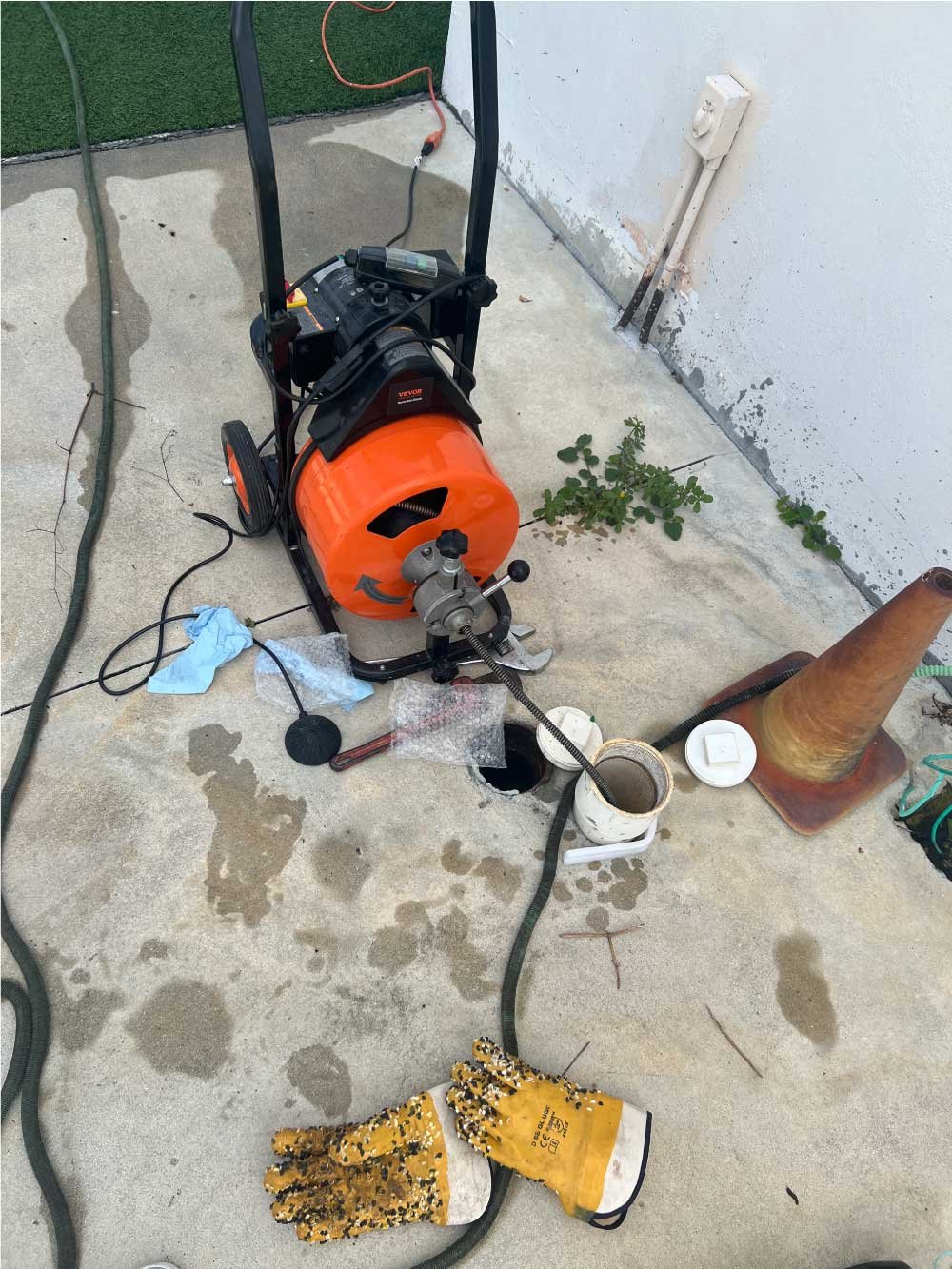 Sewer drain cleaning equipment set up outside a property