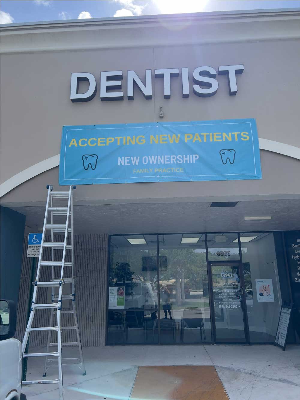 Commercial dental office exterior with a ladder set up for maintenance work